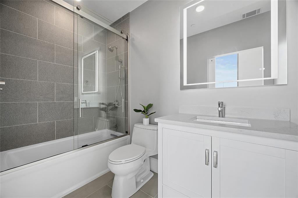 350 Oliver Avenue, Unit 1503 Pittsburgh, PA 15222 - Photo 22 of 43 a bathroom with a sink a toilet and shower