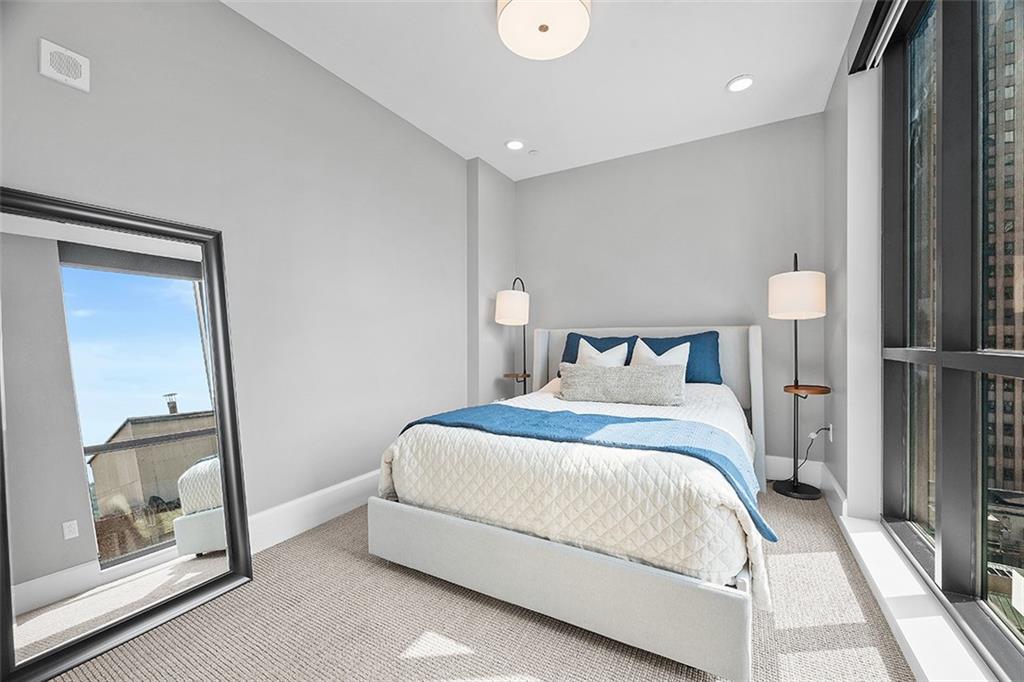 350 Oliver Avenue, Unit 1503 Pittsburgh, PA 15222 - Photo 23 of 43 a bedroom with a bed and a mirror