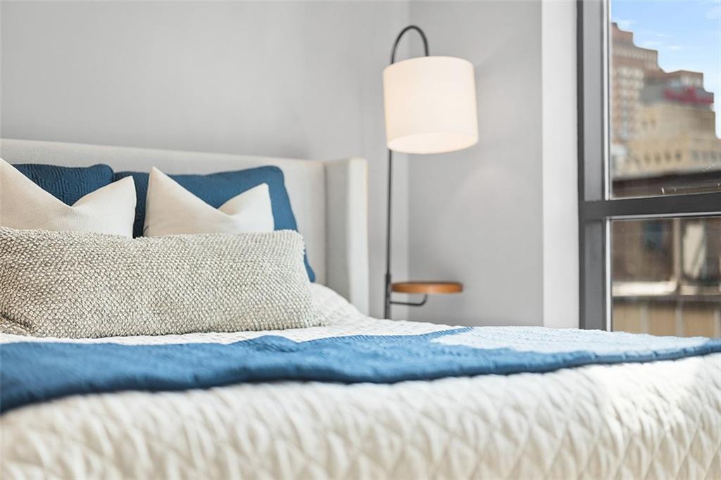 350 Oliver Avenue, Unit 1503 Pittsburgh, PA 15222 - Photo 24 of 43 a bedroom with a bed and a painting on the wall