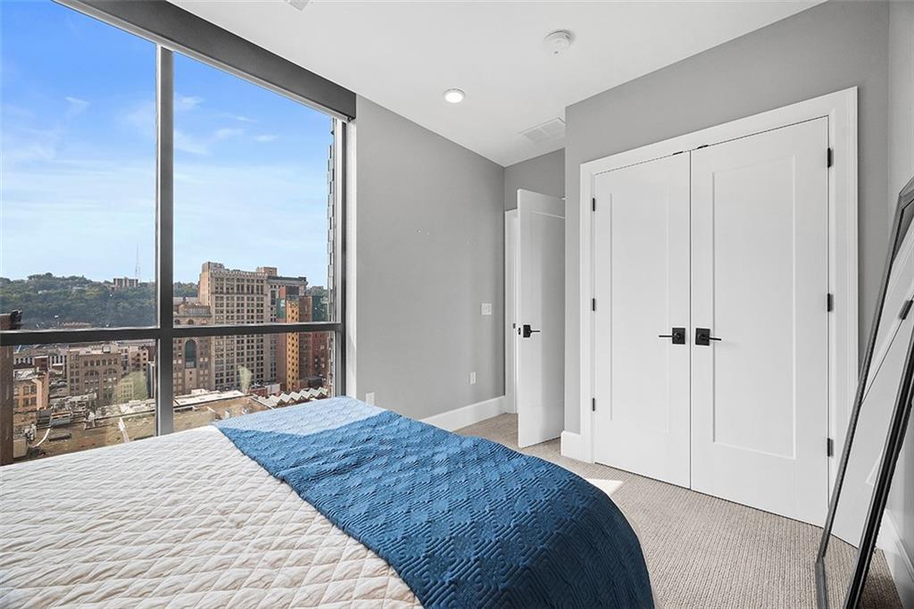 350 Oliver Avenue, Unit 1503 Pittsburgh, PA 15222 - Photo 25 of 43 a bedroom with a bed and a large window