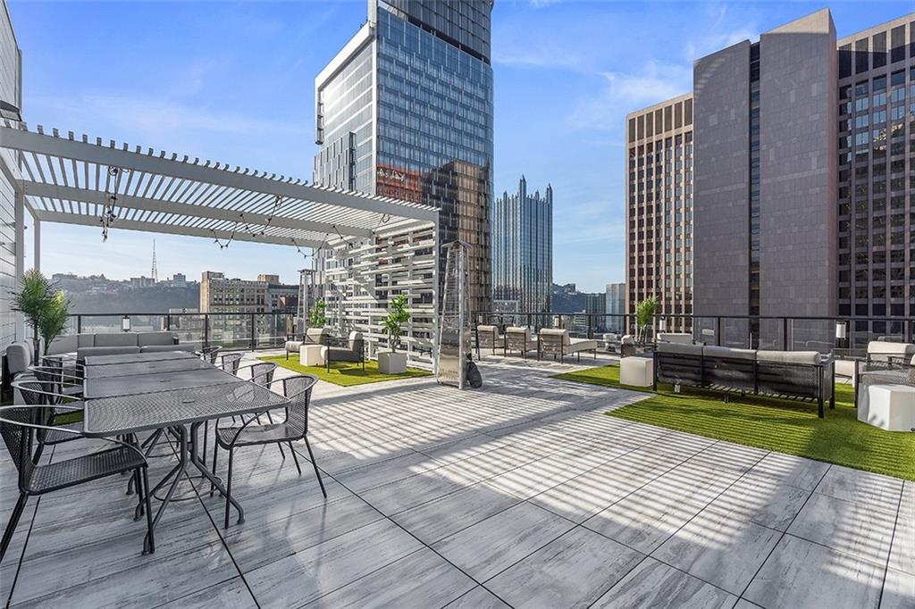 350 Oliver Avenue, Unit 1503 Pittsburgh, PA 15222 - Photo 34 of 43 a view of a patio with a table and chairs and wooden fence