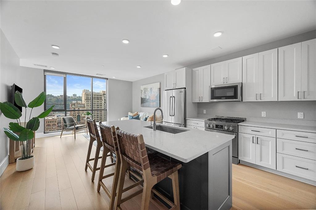 350 Oliver Avenue, Unit 1503 Pittsburgh, PA 15222 - Photo 10 of 43 a view of a dining room with furniture window and wooden floor