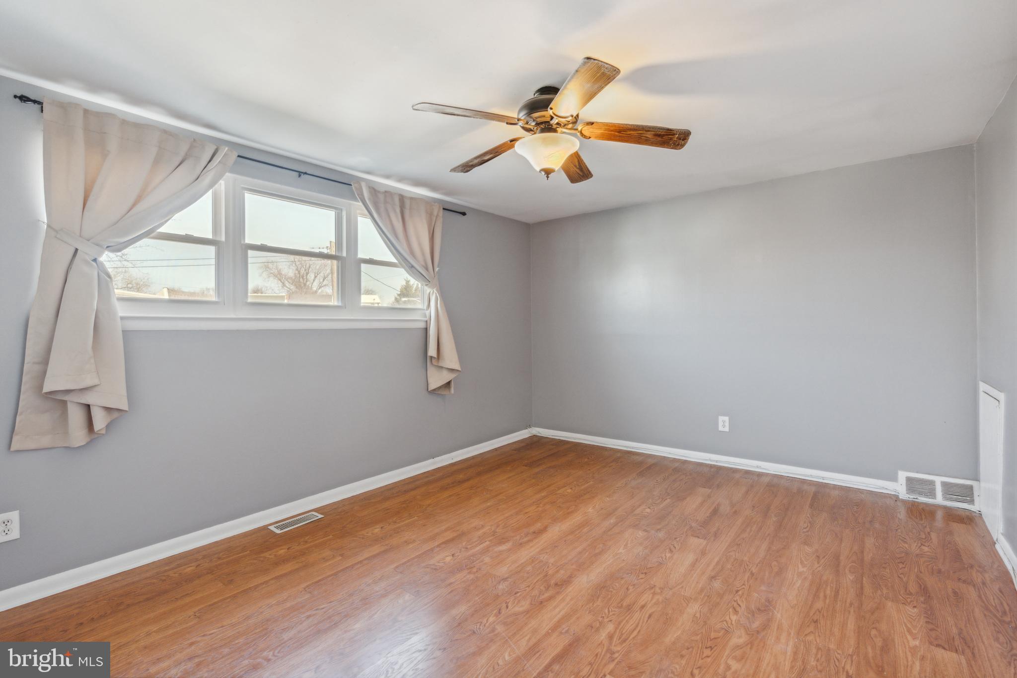 3214 Morning Glory Road Philadelphia, PA 19154 - Photo 17 of 29 wooden floor in an empty room with a window