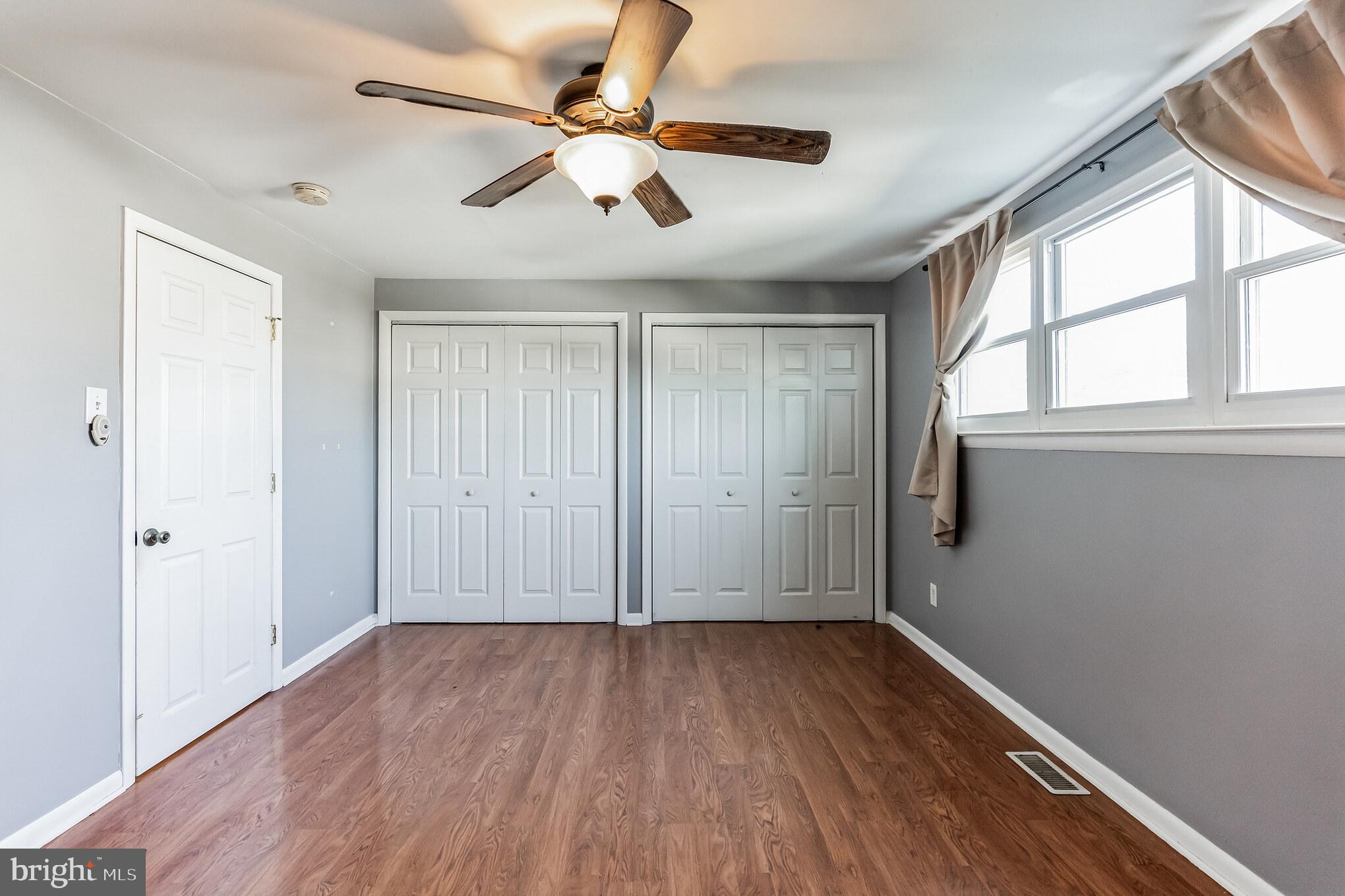 3214 Morning Glory Road Philadelphia, PA 19154 - Photo 19 of 29 an empty room with wooden floor fan and windows