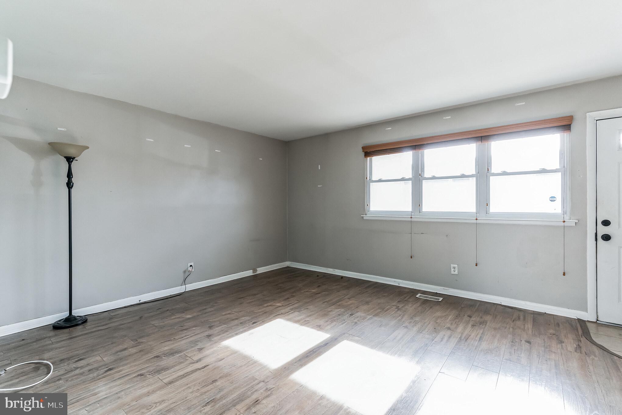 3214 Morning Glory Road Philadelphia, PA 19154 - Photo 4 of 29 an empty room with wooden floor and windows