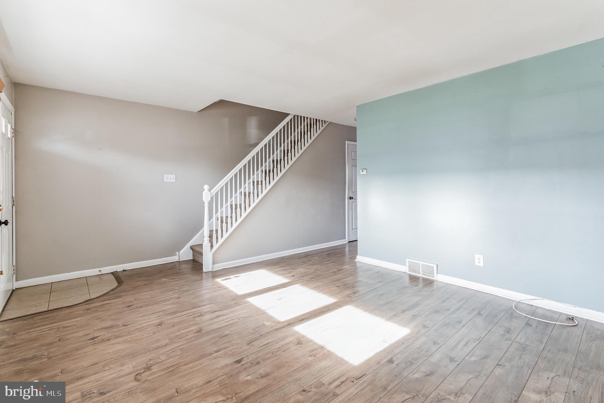 3214 Morning Glory Road Philadelphia, PA 19154 - Photo 7 of 29 a view of an empty room with wooden floor and stairs