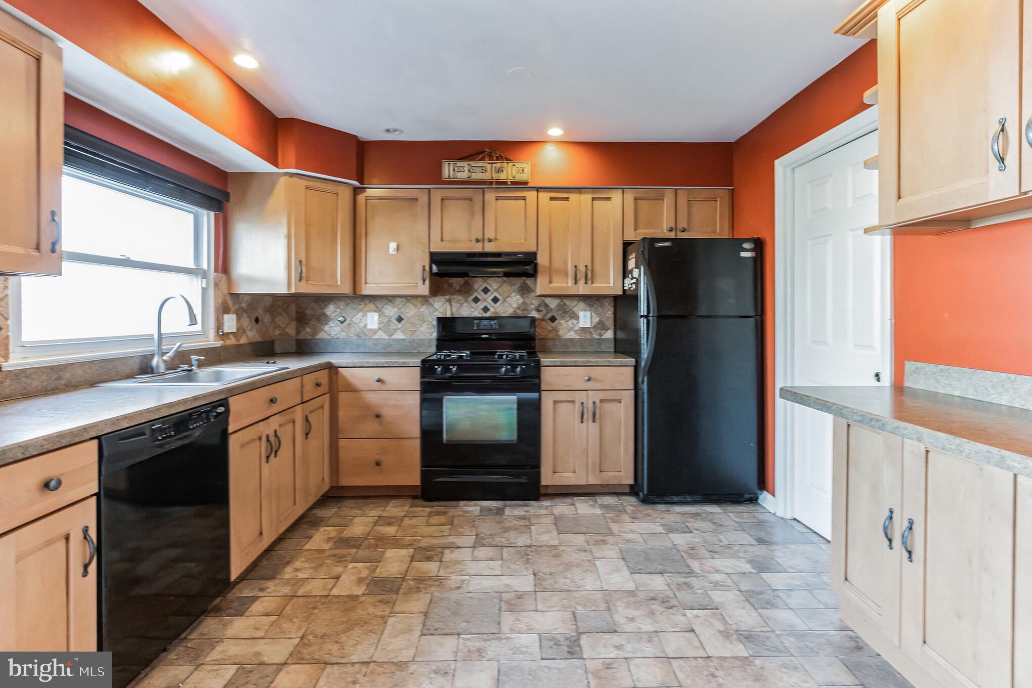 3214 Morning Glory Road Philadelphia, PA 19154 - Photo 9 of 29 a kitchen with a refrigerator sink and cabinets