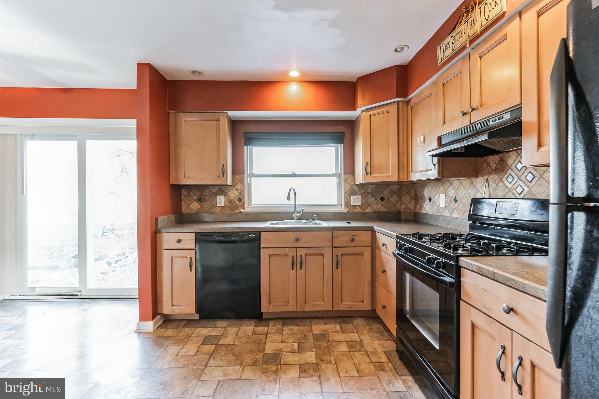 3214 Morning Glory Road Philadelphia, PA 19154 - Photo 10 of 29 a kitchen with stainless steel appliances granite countertop a stove a sink and a microwave