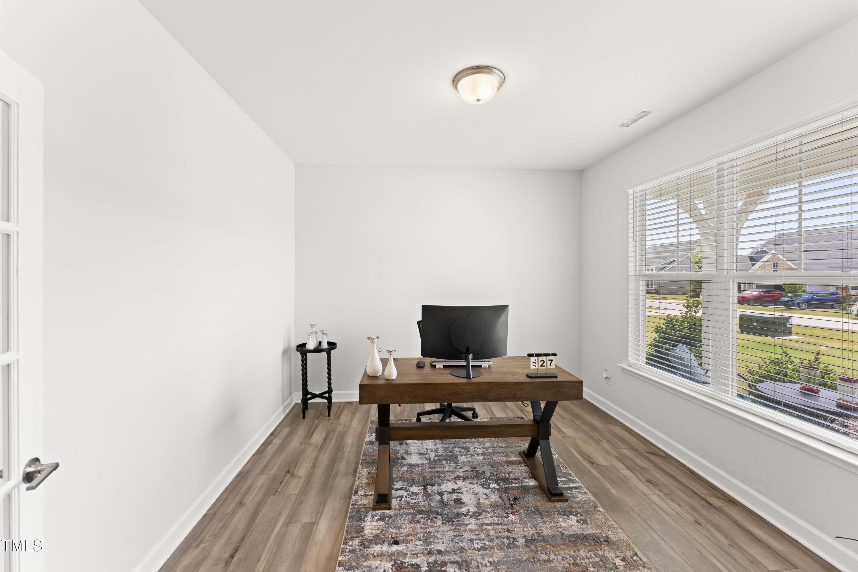 205 Morningside Lane Angier, NC 27501 - Photo 10 of 46 a view of a workspace with furniture and a window