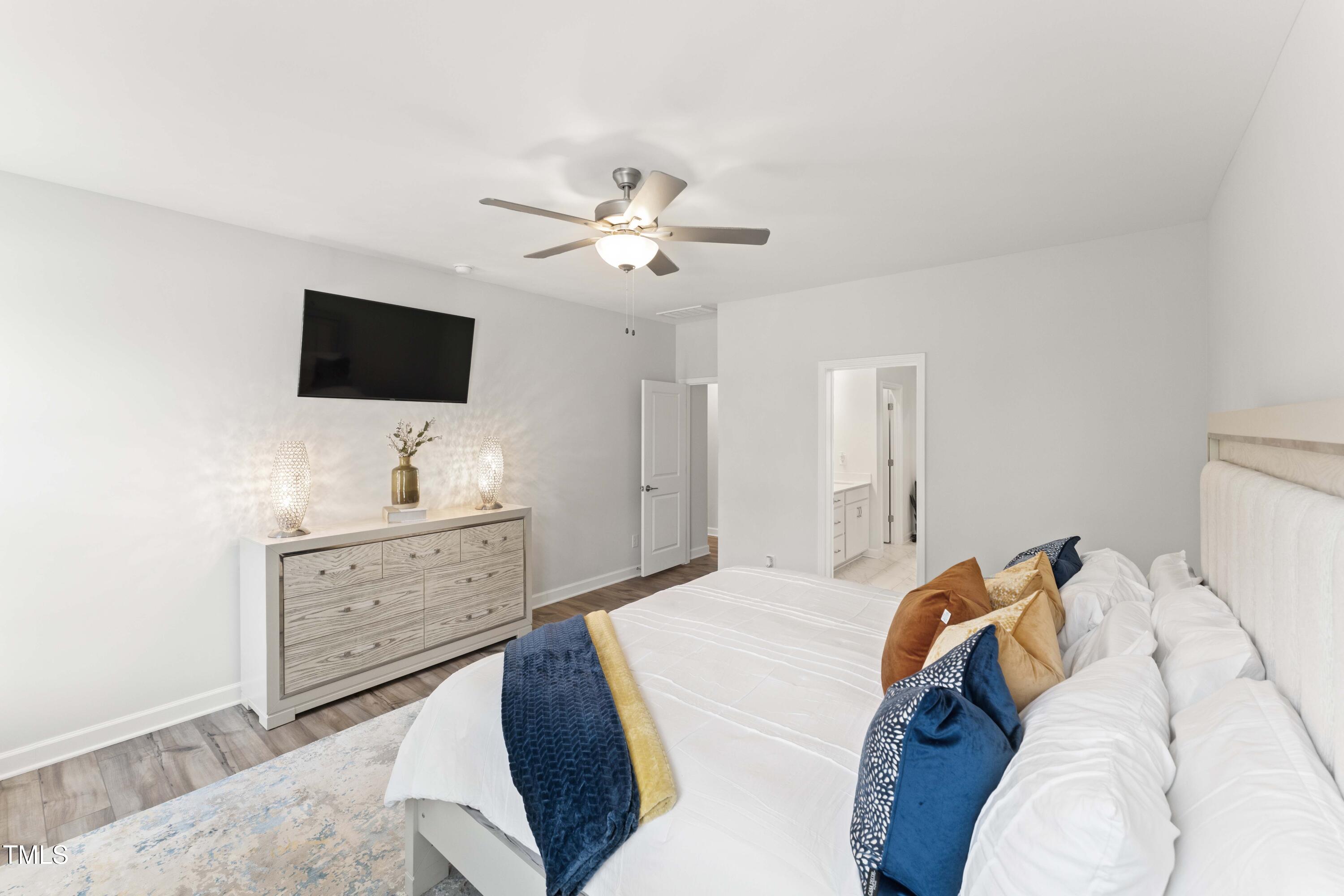 205 Morningside Lane Angier, NC 27501 - Photo 22 of 46 a bedroom with a bed and a flat screen tv