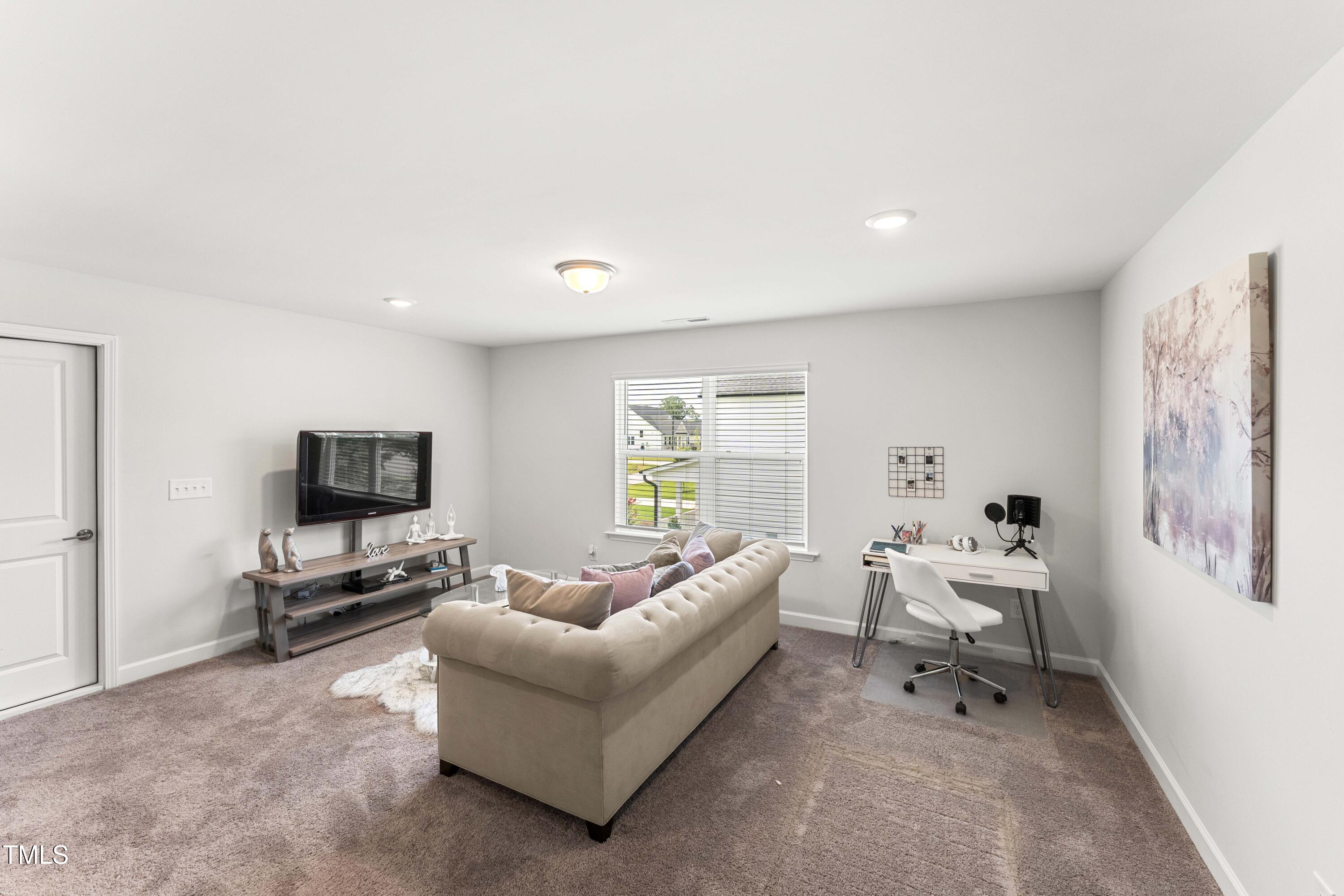 205 Morningside Lane Angier, NC 27501 - Photo 26 of 46 a living room with furniture and a flat screen tv