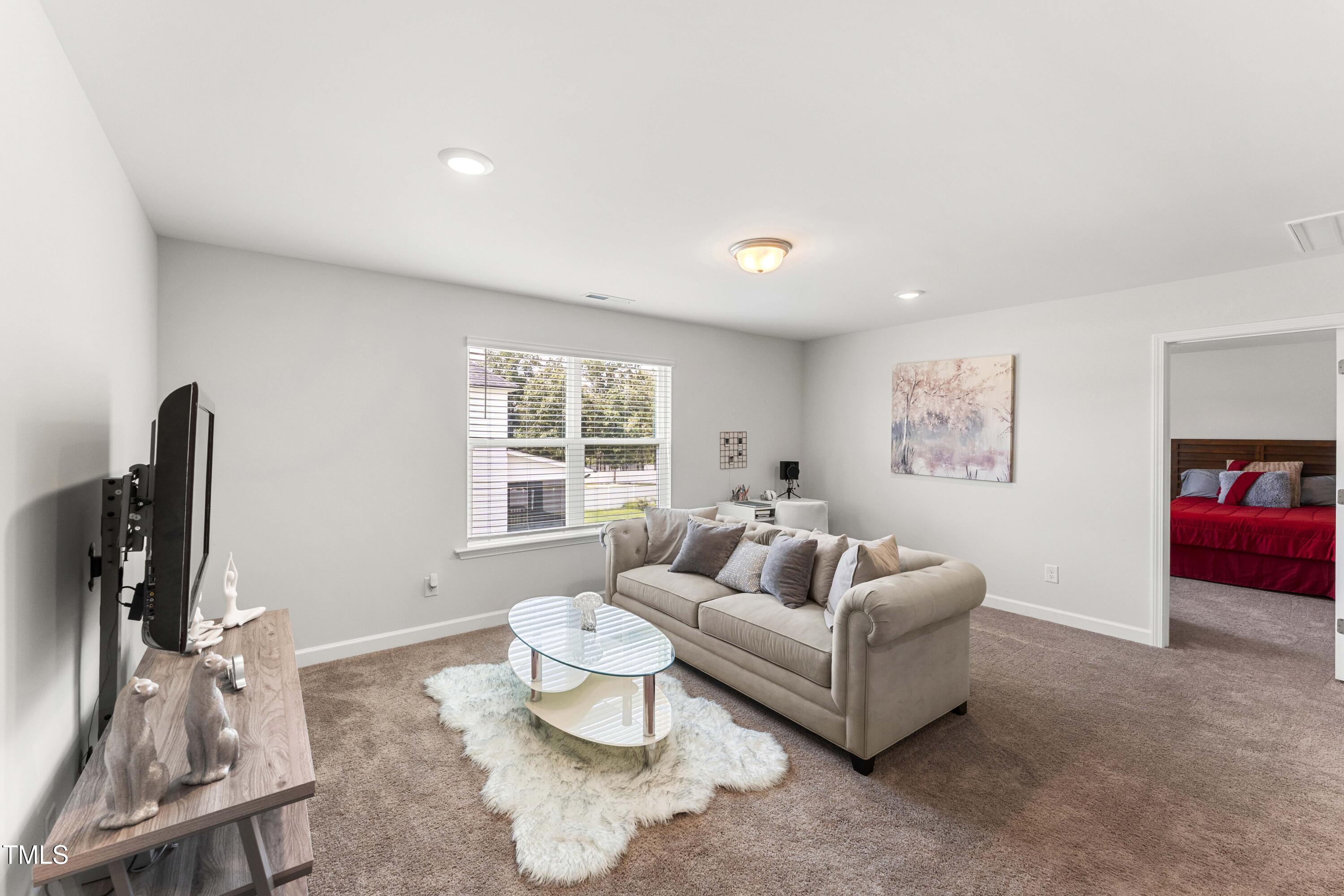 205 Morningside Lane Angier, NC 27501 - Photo 27 of 46 a living room with furniture and a flat screen tv