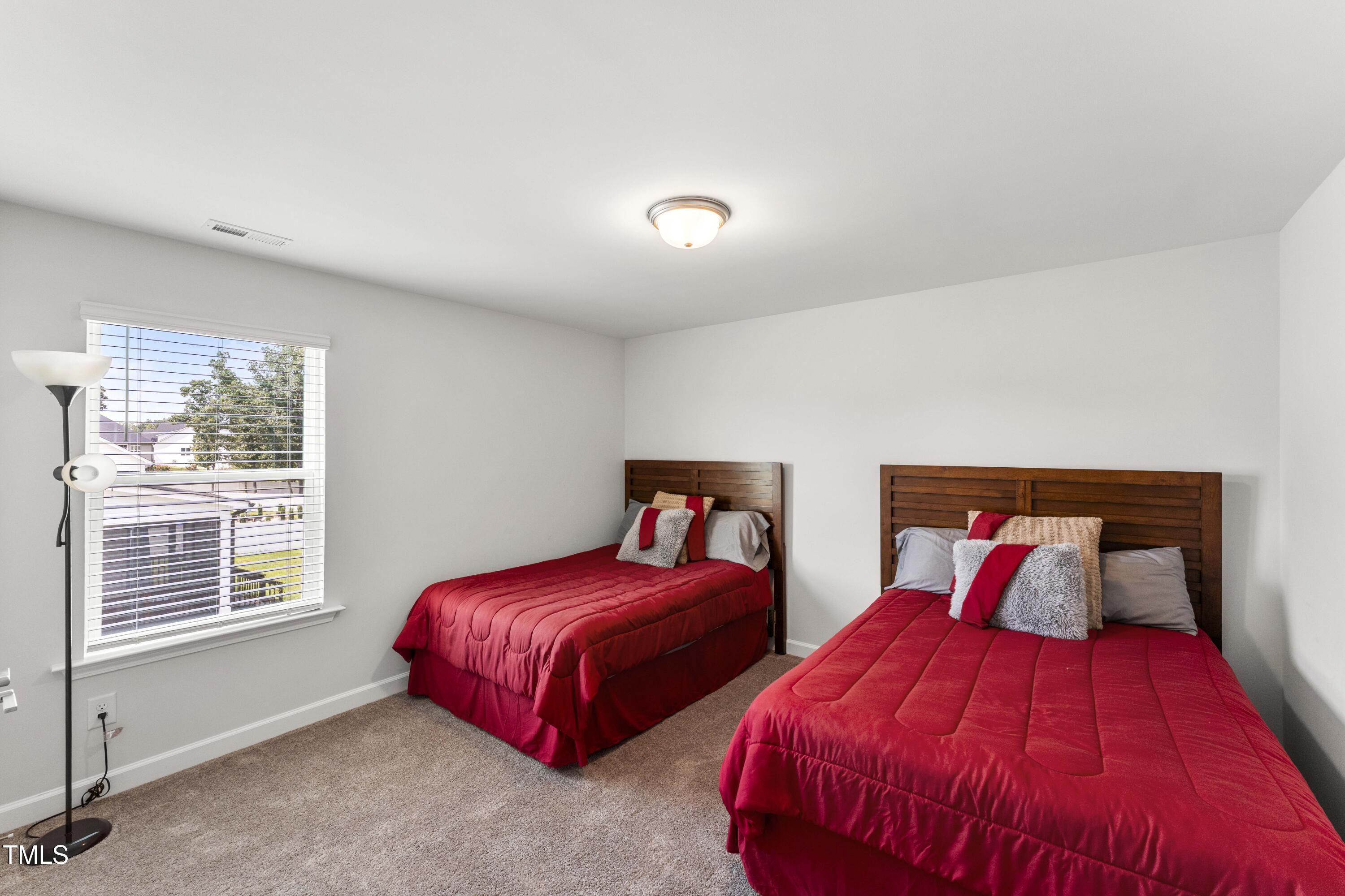 205 Morningside Lane Angier, NC 27501 - Photo 28 of 46 a bedroom with two beds and a window