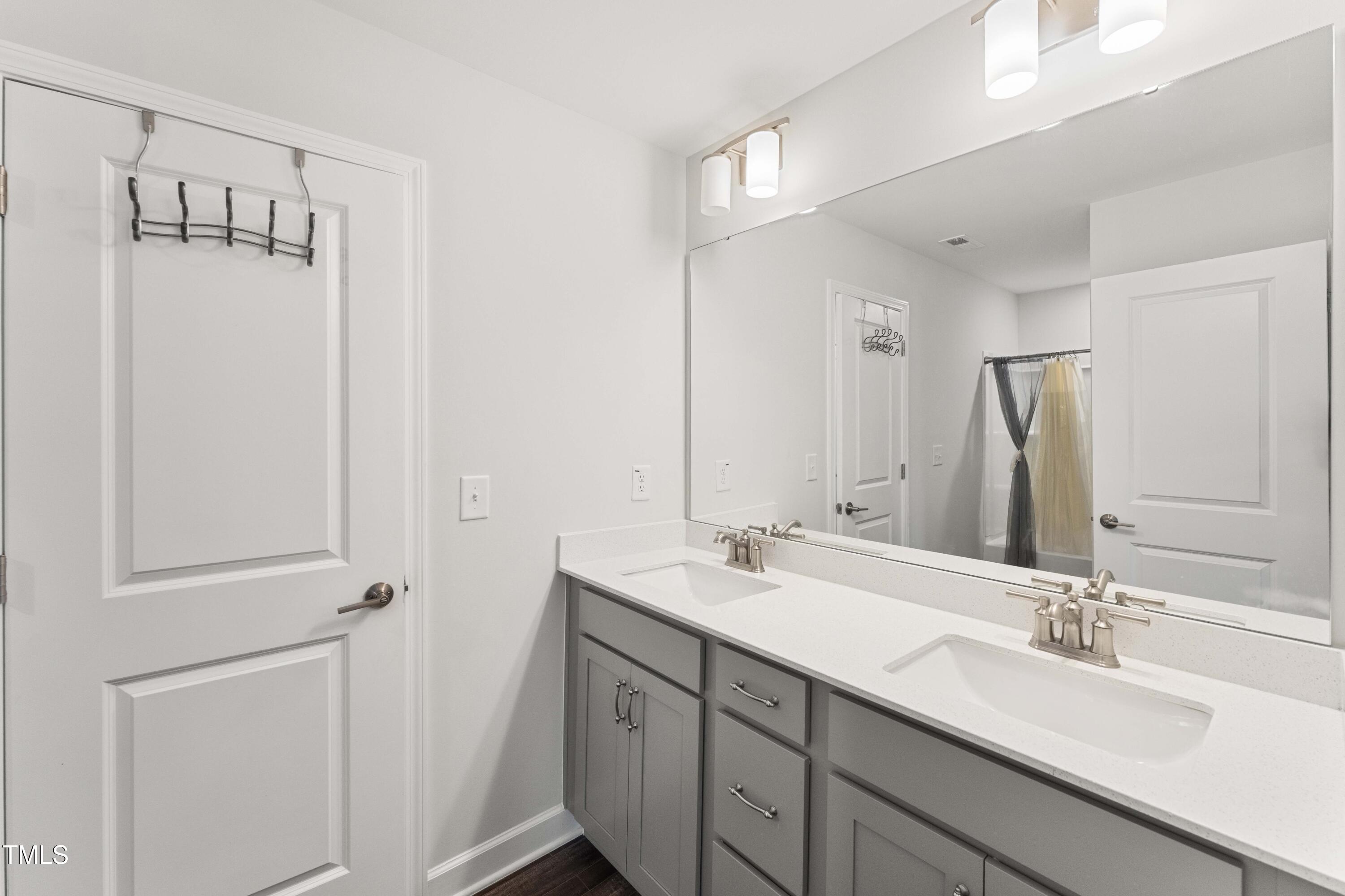 205 Morningside Lane Angier, NC 27501 - Photo 31 of 46 a bathroom with 2 sink and a mirror