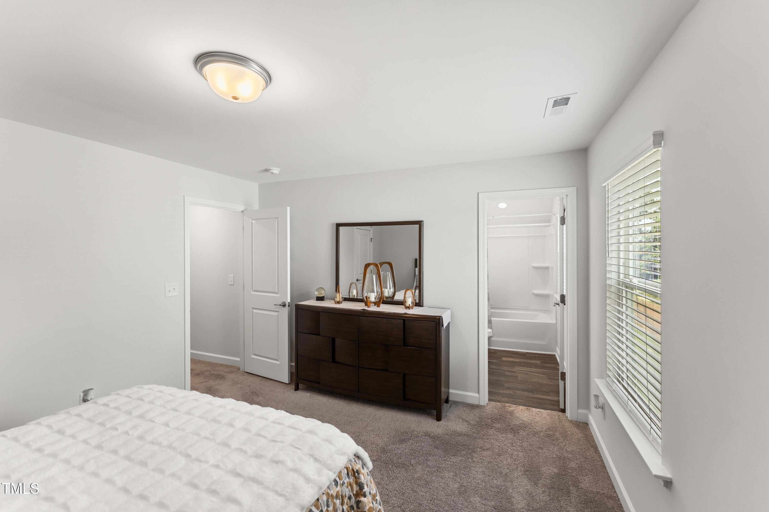 205 Morningside Lane Angier, NC 27501 - Photo 35 of 46 a bedroom with a bed and a dresser