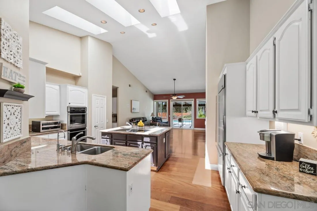 15928 Cumberland Drive Poway, CA 92064 - Photo 14 of 41 a kitchen with sink stove top oven and cabinets