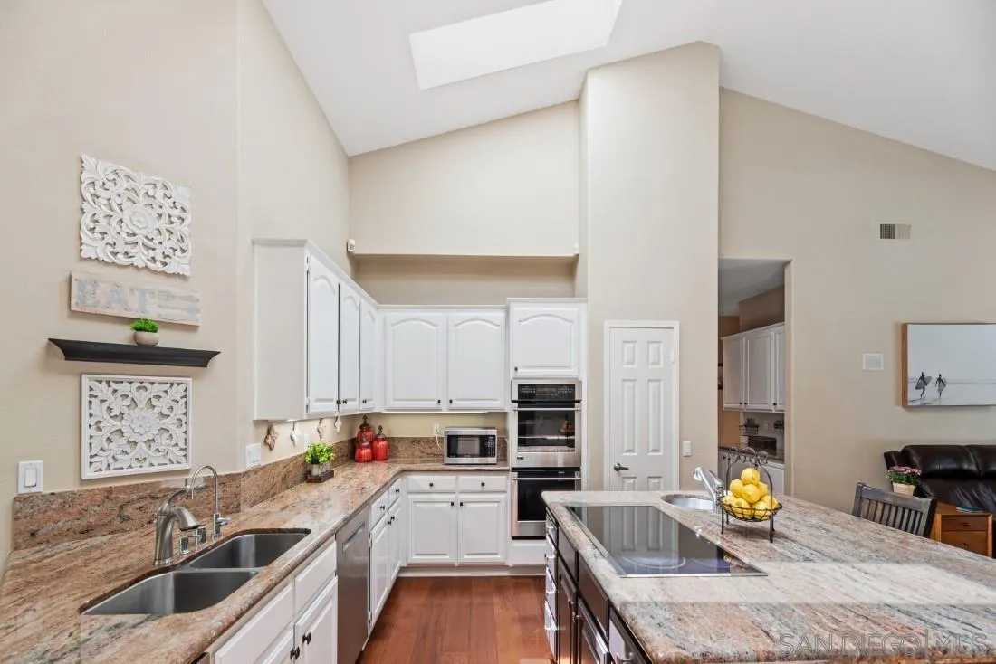 15928 Cumberland Drive Poway, CA 92064 - Photo 15 of 41 a kitchen with a sink stove and cabinets