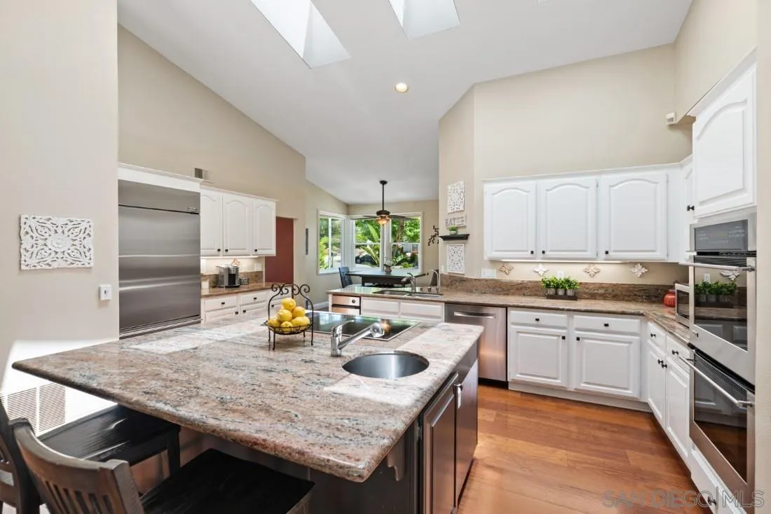 15928 Cumberland Drive Poway, CA 92064 - Photo 16 of 41 a kitchen with a stove a refrigerator and white cabinets