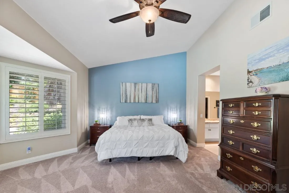 15928 Cumberland Drive Poway, CA 92064 - Photo 19 of 41 a bedroom with a large bed and a chandelier