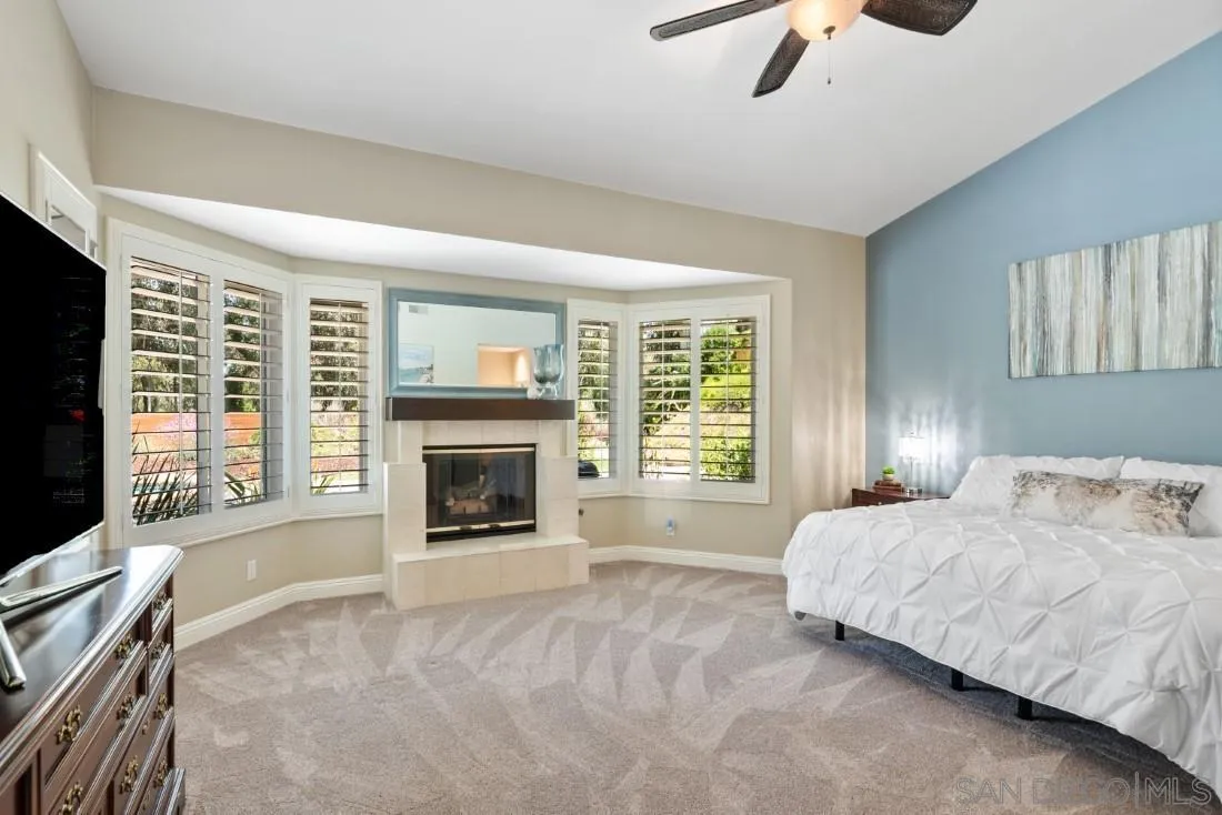 15928 Cumberland Drive Poway, CA 92064 - Photo 20 of 41 a spacious bedroom with a bed and a fireplace