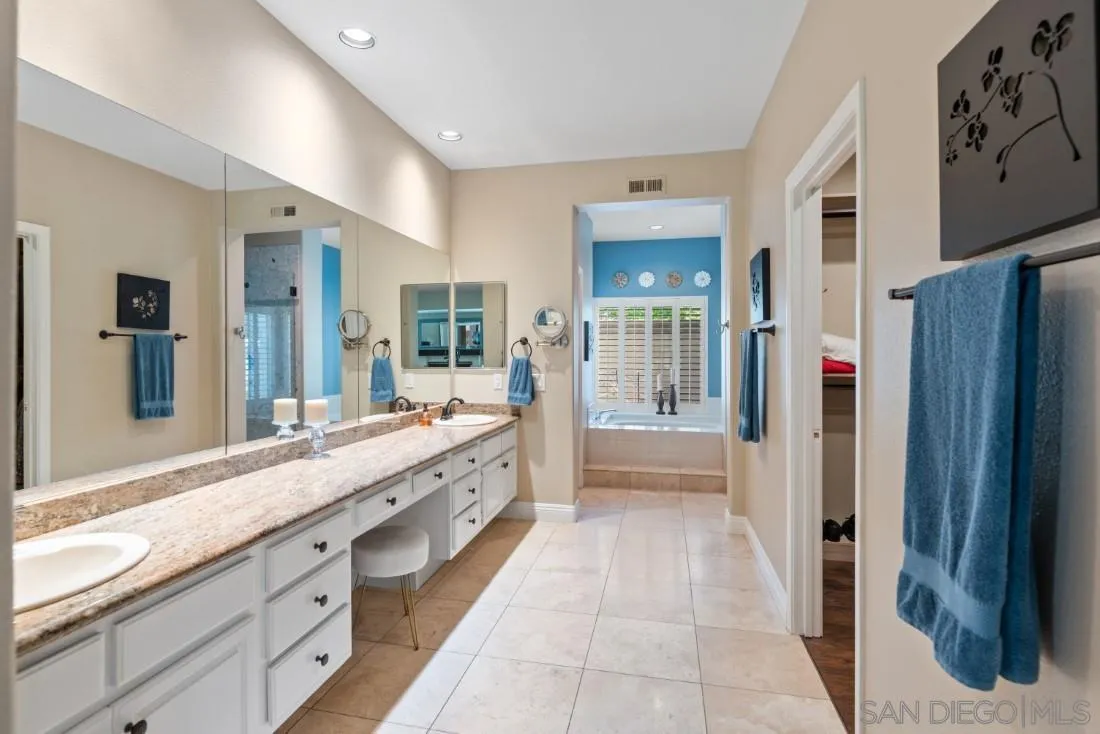 15928 Cumberland Drive Poway, CA 92064 - Photo 22 of 41 a bathroom with a tub sink shower and mirror