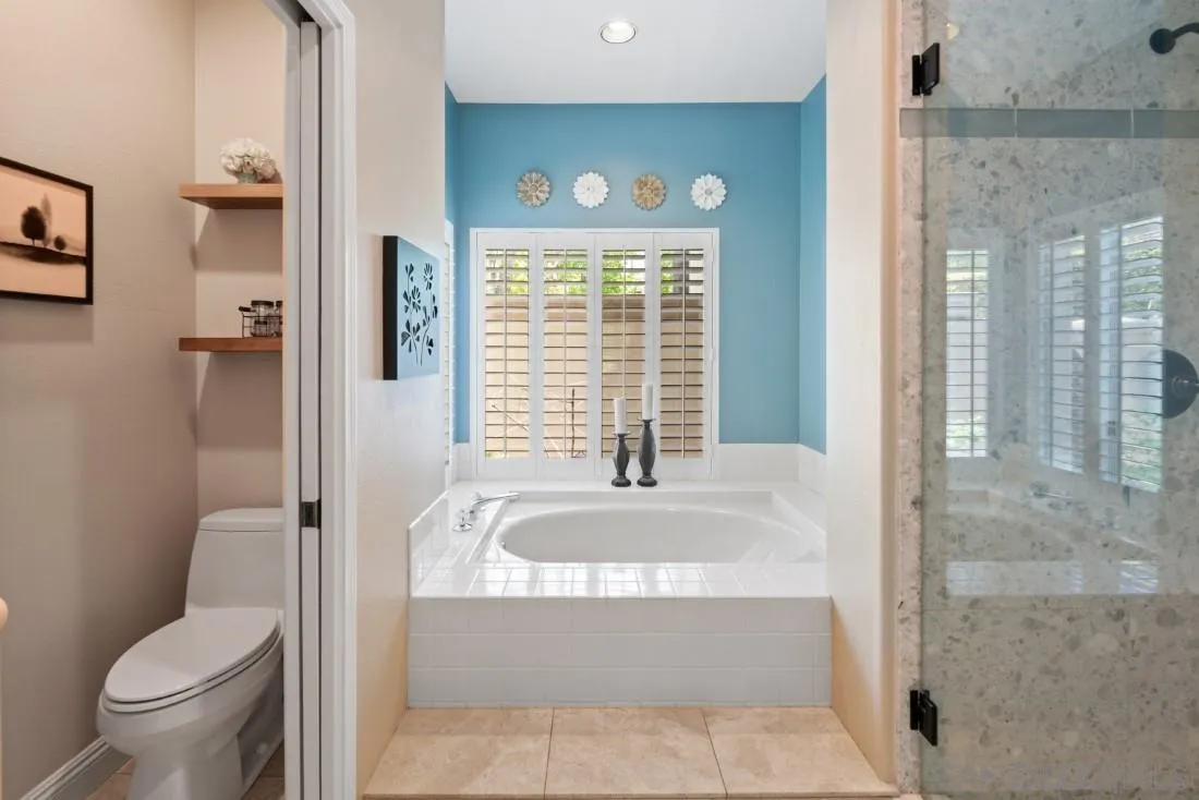 15928 Cumberland Drive Poway, CA 92064 - Photo 23 of 41 a bathroom with a granite countertop toilet a sink and a bathtub