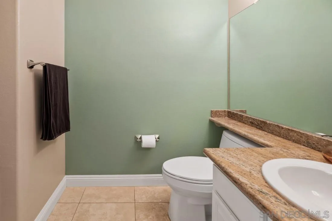 15928 Cumberland Drive Poway, CA 92064 - Photo 26 of 41 a bathroom with a granite countertop toilet and a sink
