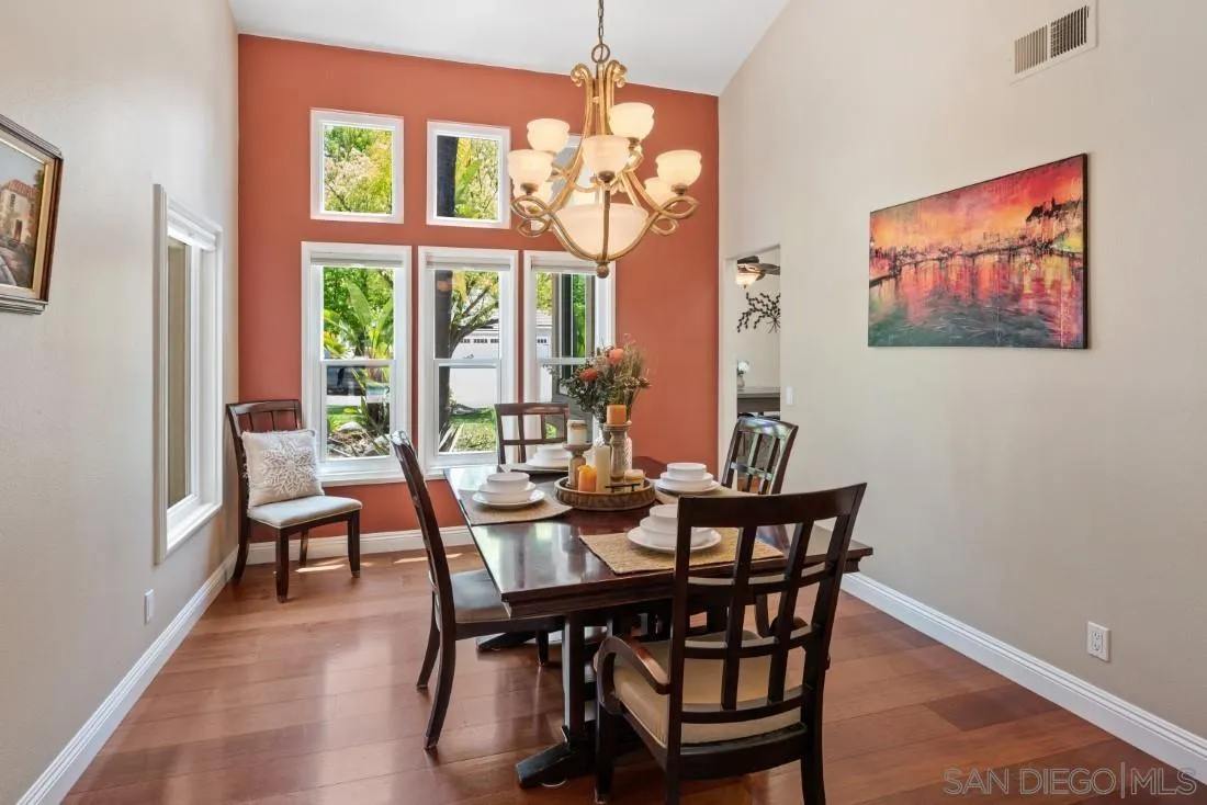 15928 Cumberland Drive Poway, CA 92064 - Photo 10 of 41 a dining room with furniture a chandelier and wooden floor