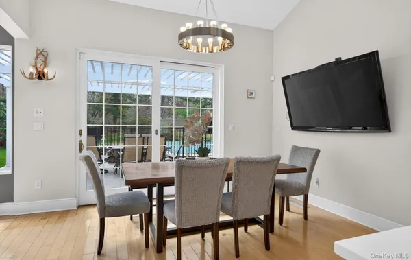 a view of a dining room with furniture window and wooden floor