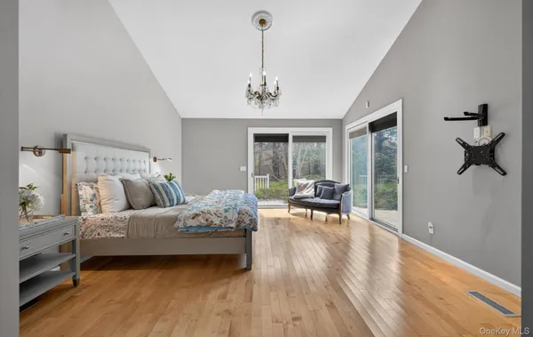 a bedroom with a bed and a chandelier