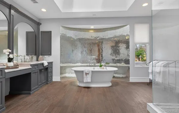 a kitchen with a sink and a large mirror next to a window