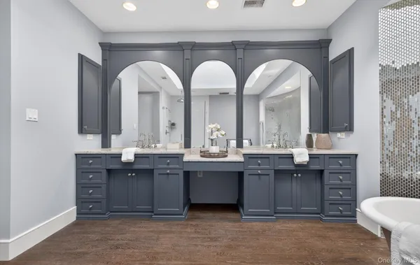 a spacious bathroom with a granite countertop sink and a mirror