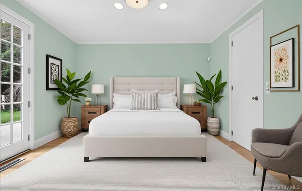 a spacious bedroom with a bed and a potted plant