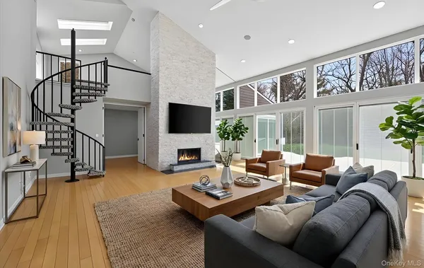 a living room with furniture fireplace and a flat screen tv