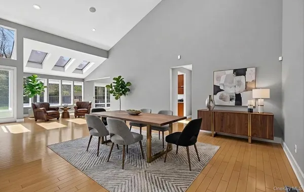 a dining room with furniture window and wooden floor