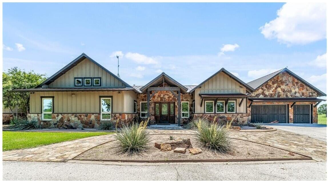 a front view of a house with garden