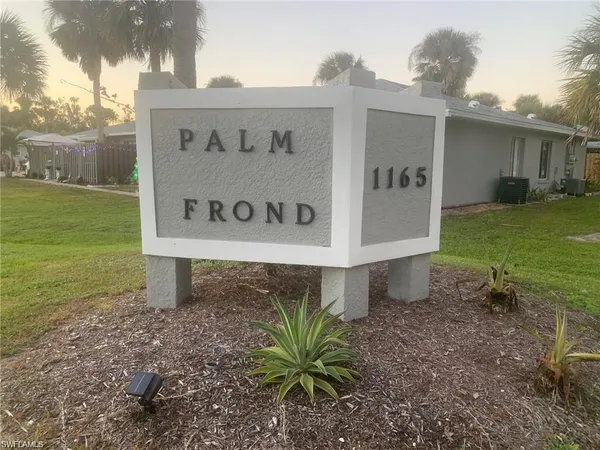 a sign that is sitting in front of a house