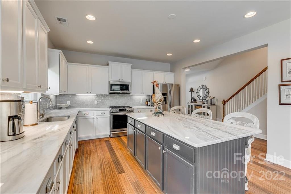 1007 Kaiser Way Fort Mill, SC 29715 - Photo 11 of 48 a kitchen with a sink a counter top space stainless steel appliances and cabinets