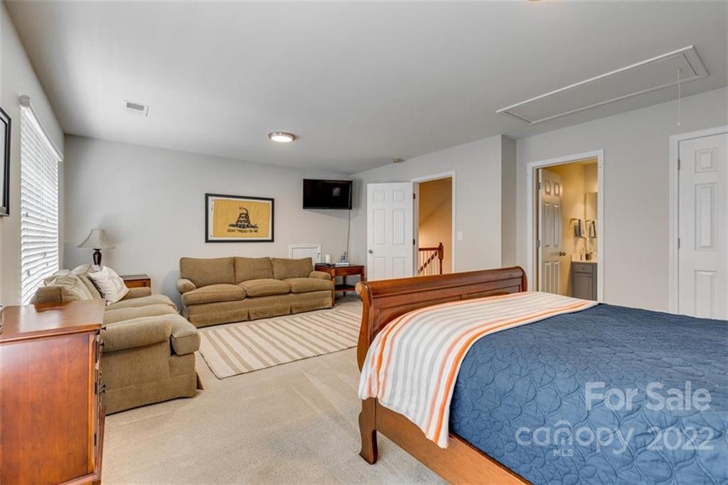 1007 Kaiser Way Fort Mill, SC 29715 - Photo 34 of 48 a spacious bedroom with a bed and a couch