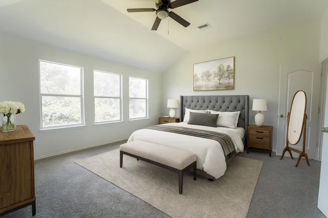 a bedroom with a bed and a window