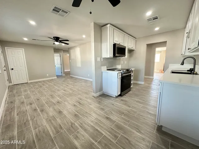 a view of a kitchen with microwave and cabinets
