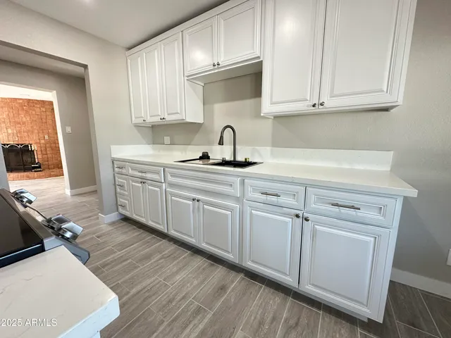 a view of a kitchen with sink and cabinets