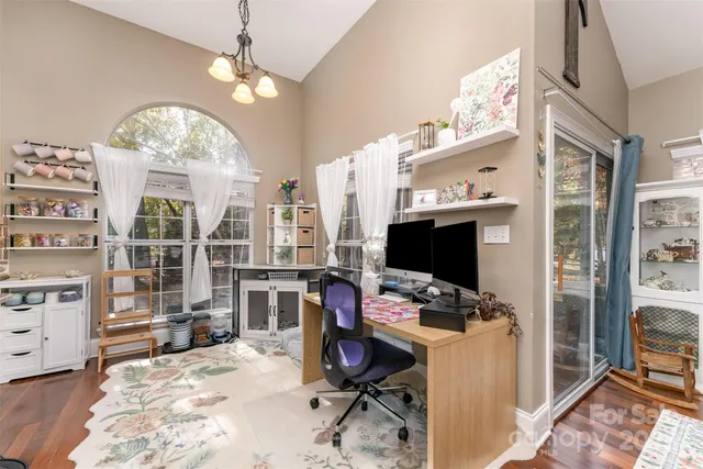a view of a workspace with furniture and a window