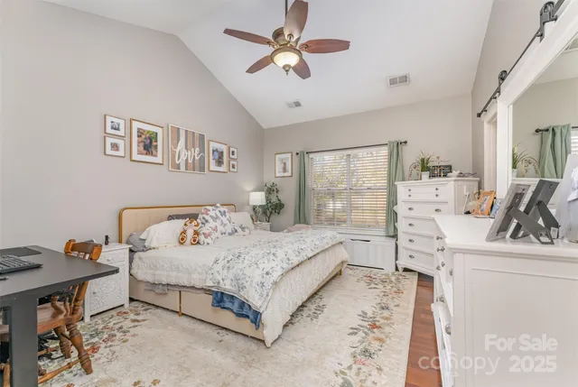 a spacious bedroom with a bed and a large window with the outer view