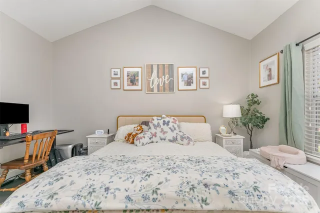 a bedroom with a bed and a desk