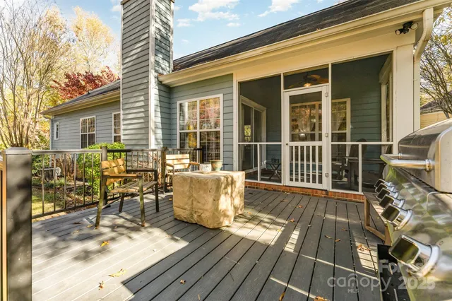 a view of a two chairs and table on the wooden deck