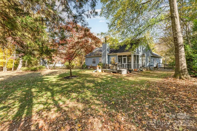 a view of swimming pool with outdoor seating and trees