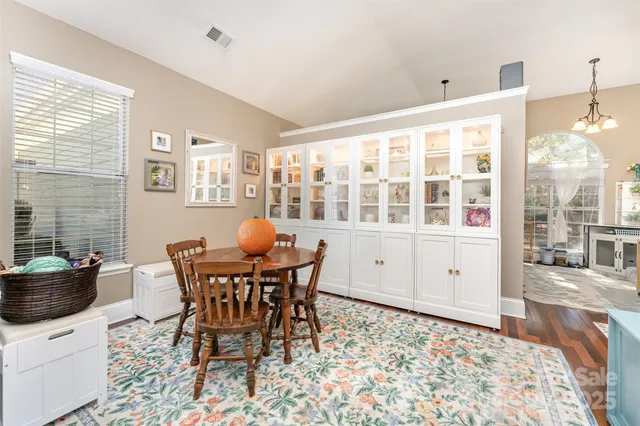 a view of a dining room with furniture and chandelier