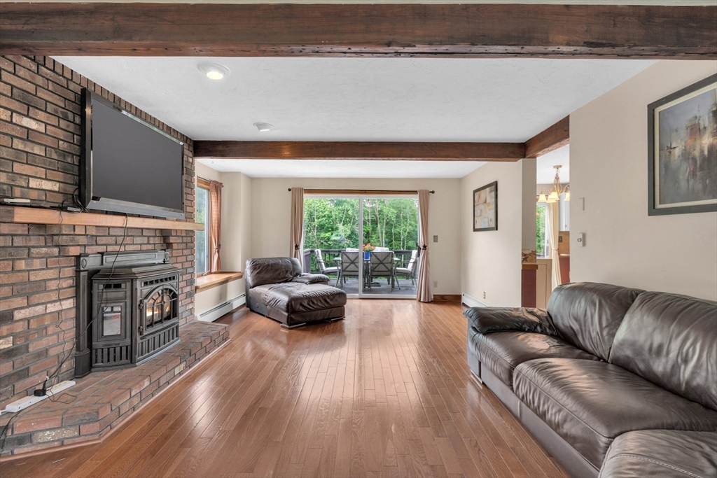 157 Podunk Road Sturbridge, MA 01566 - Photo 12 of 42 a living room with furniture and a fireplace