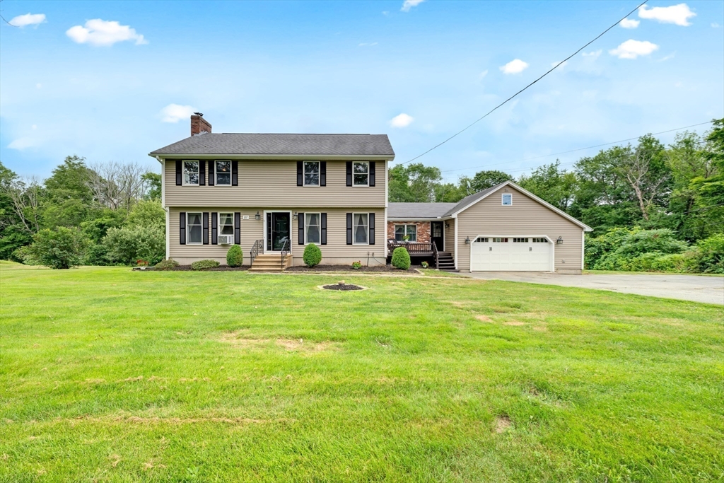 157 Podunk Road Sturbridge, MA 01566 - Photo 3 of 42 a front view of a house with garden